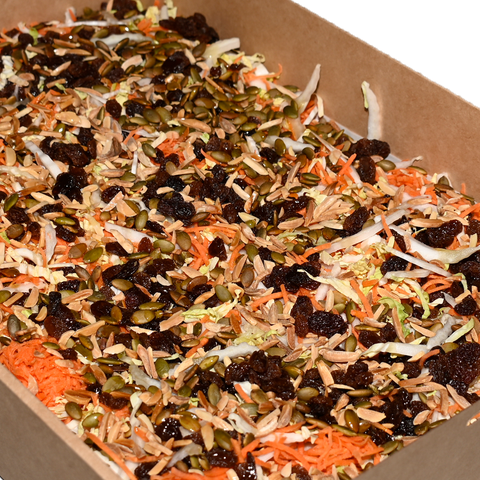 Slaw salad with shredded cabbage, grated carrot, currants, pumpkin seeds, and almonds, perfect for vegan and gluten-free catering in Sydney.