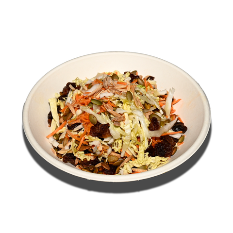 Slaw salad with shredded cabbage, grated carrot, currants, pumpkin seeds, and almonds, perfect for vegan and gluten-free catering in Sydney.
