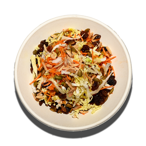 Slaw salad with shredded cabbage, grated carrot, currants, pumpkin seeds, and almonds, perfect for vegan and gluten-free catering in Sydney.